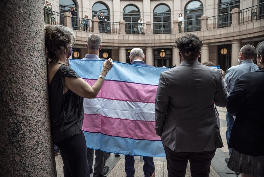 People held up a transgender flag at an event held by Equality Texas at the Capitol in Austin on Wednesday, April 14, 2021
